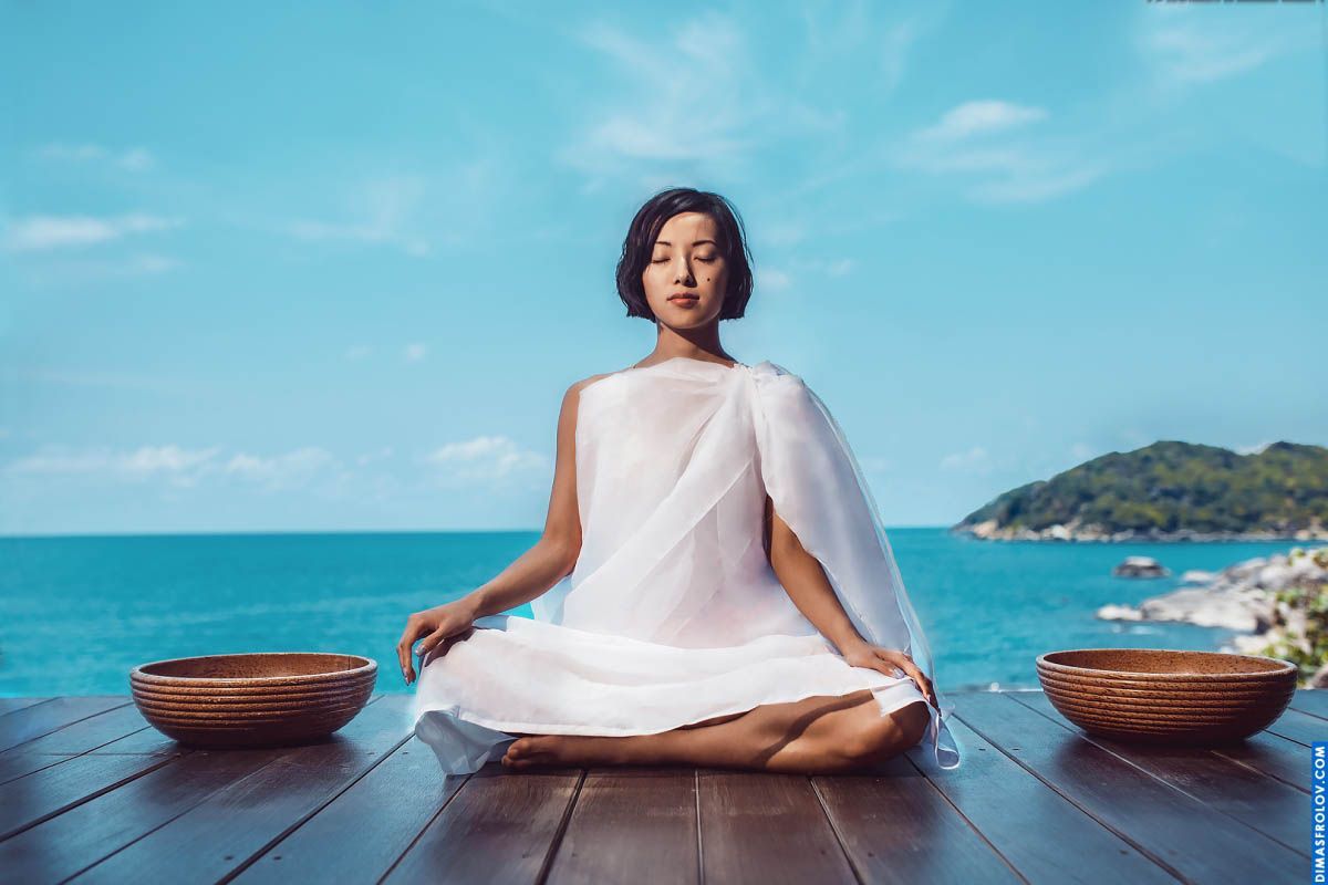 Meditative mood in a white dress during a peaceful seaside moment