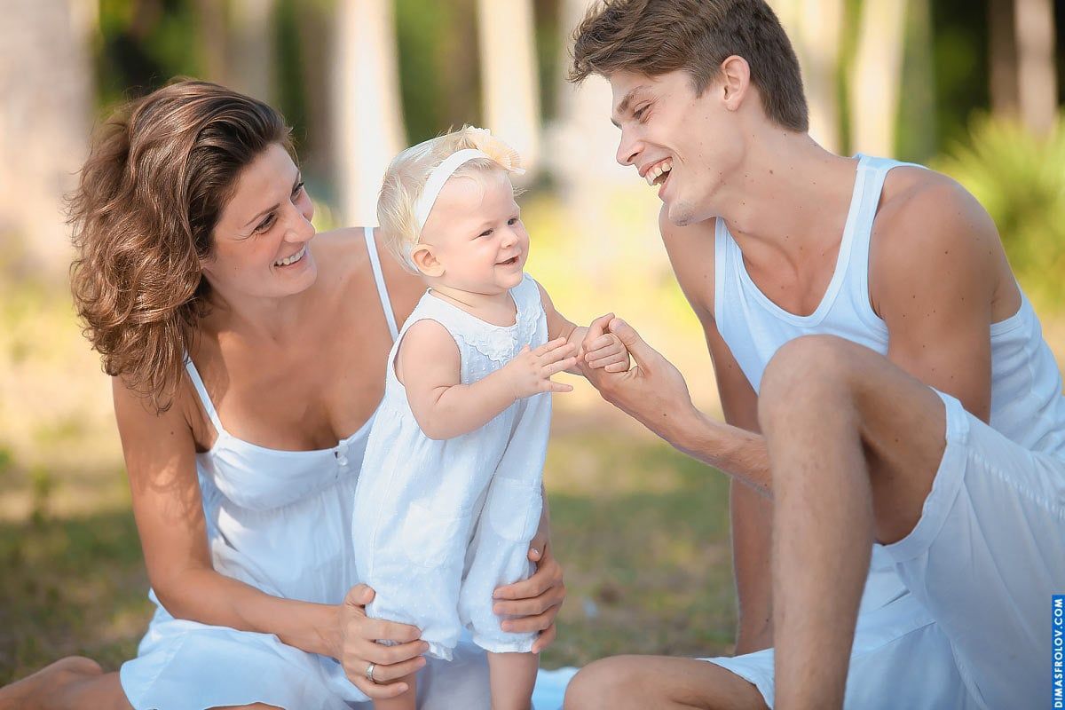 Family photo shoot on the ground — laughing together in a candid and loving portrait