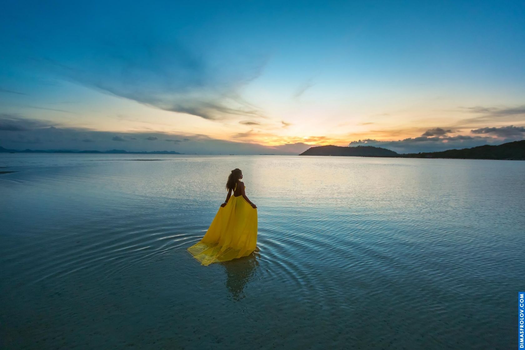 Serene moment of a girl standing in still water at twilight