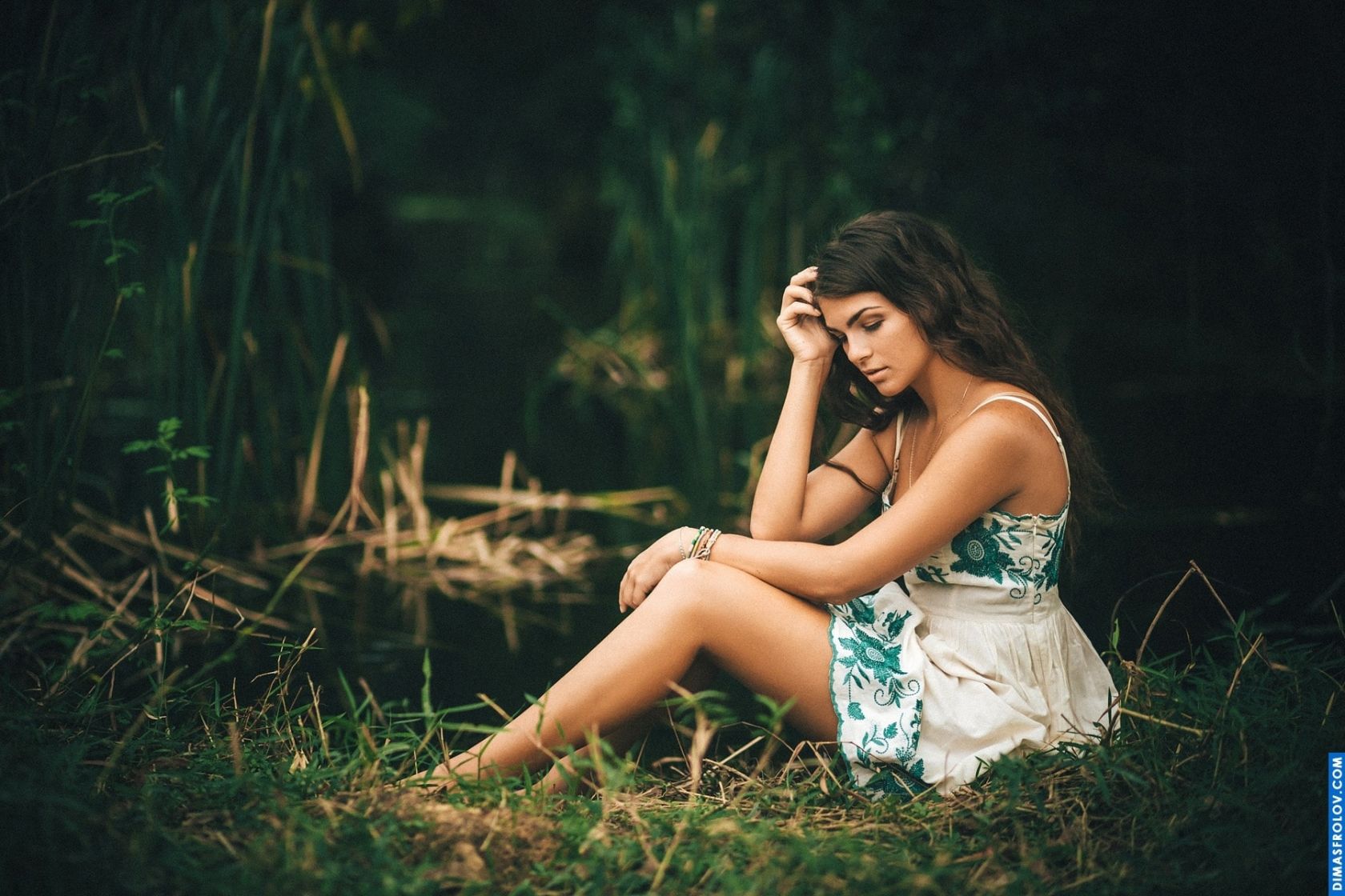 Atmospheric portrait of a young woman in nature with introspective mood