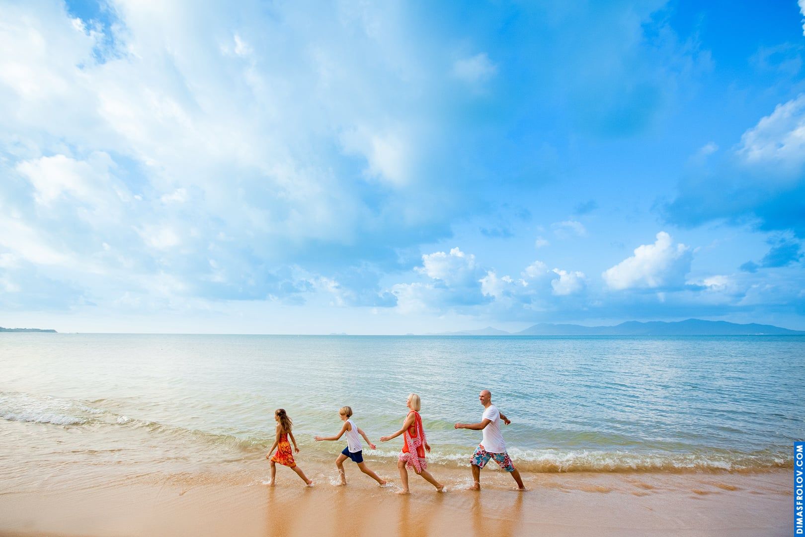 Funny family photo — walking in sync on the beach like a Beatles-style parade