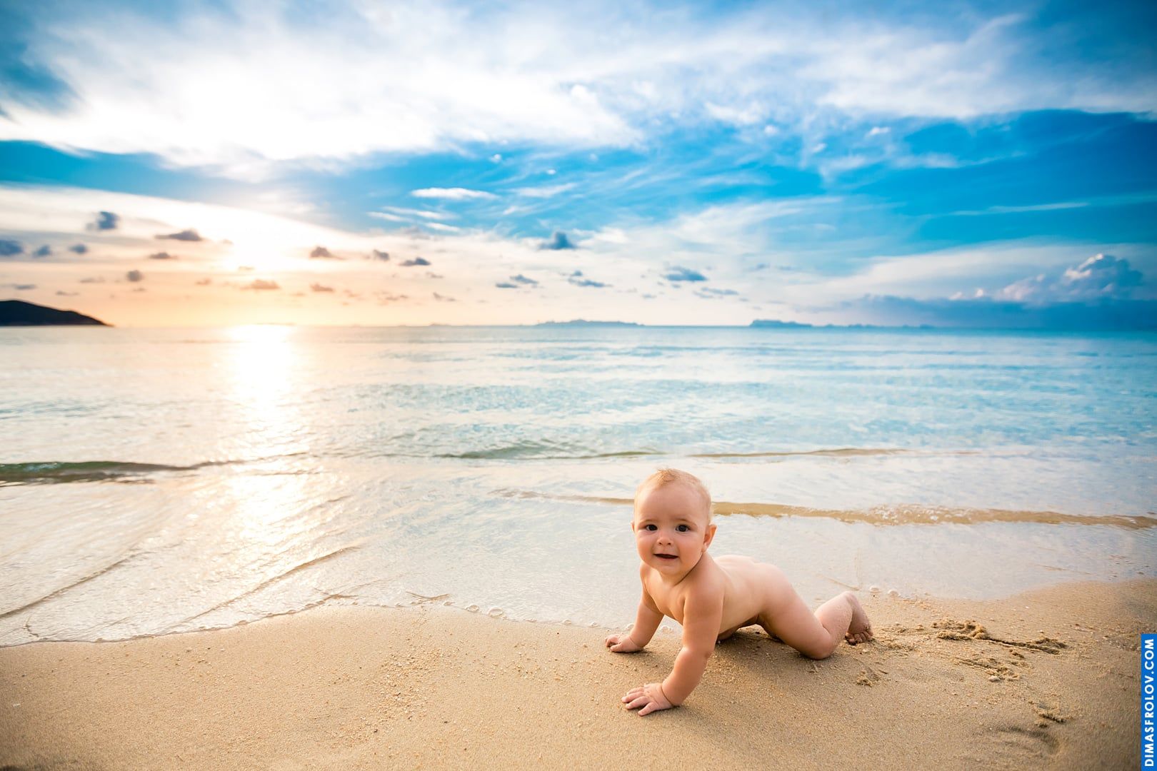 Baby beach photo shoot — sitting calmly on the sand at sunset