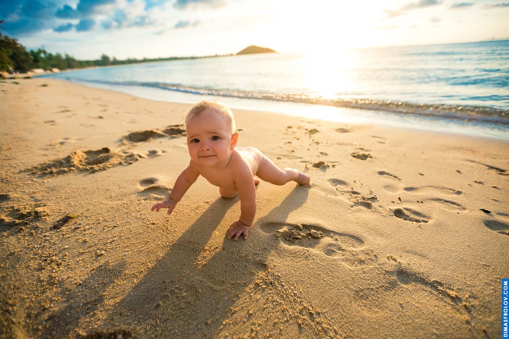 Baby crawling on the beach at sunset — golden light and tiny hands