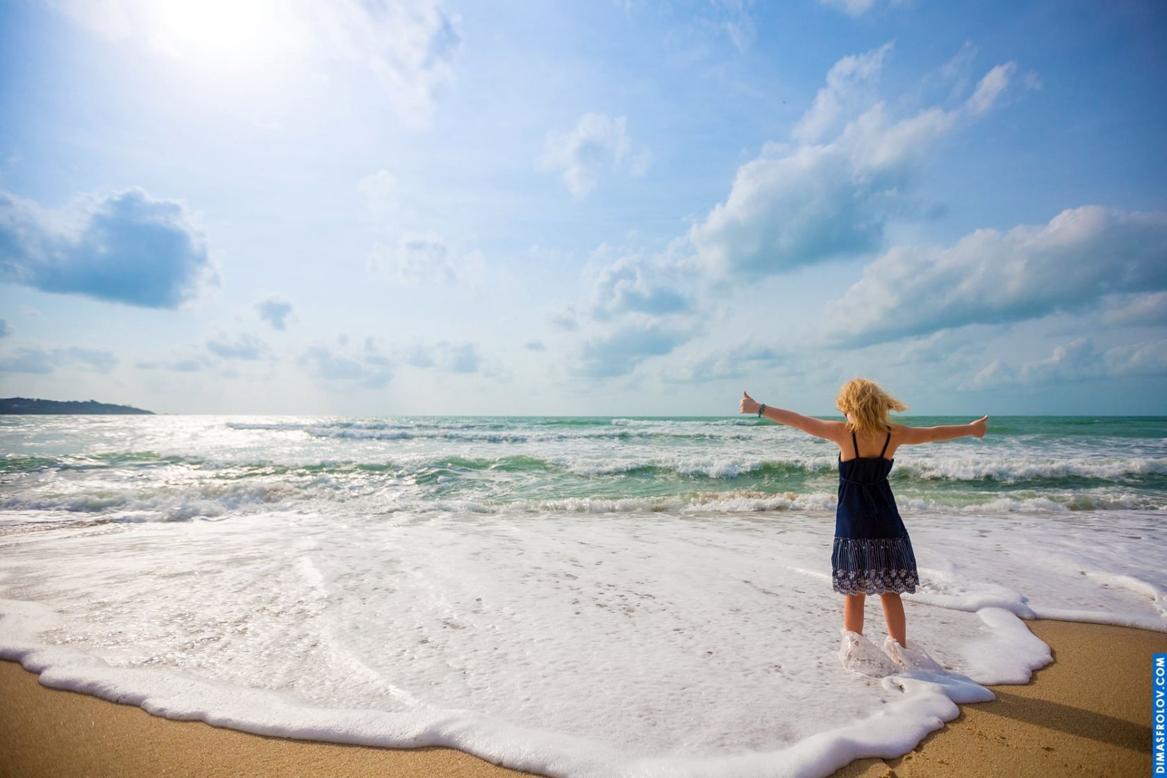Artistic kids photo on the shore — girl facing the ocean in a serene moment