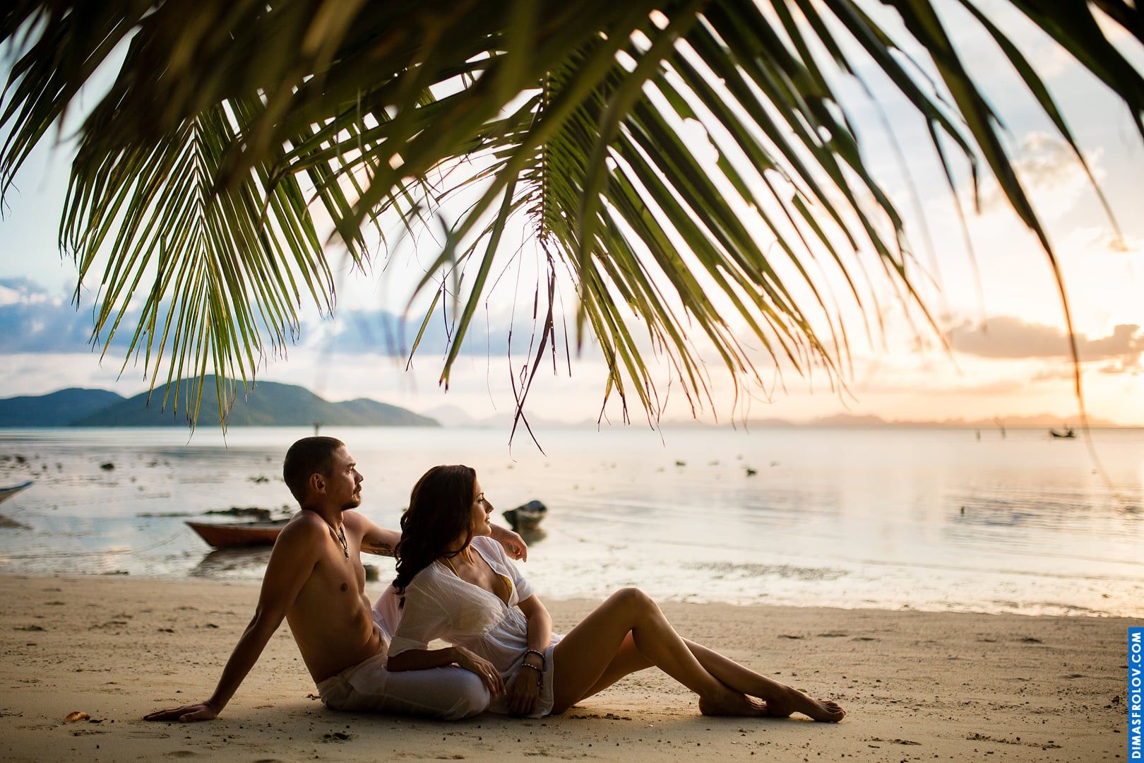 Artistic couple portrait with a dreamy tropical sunset background