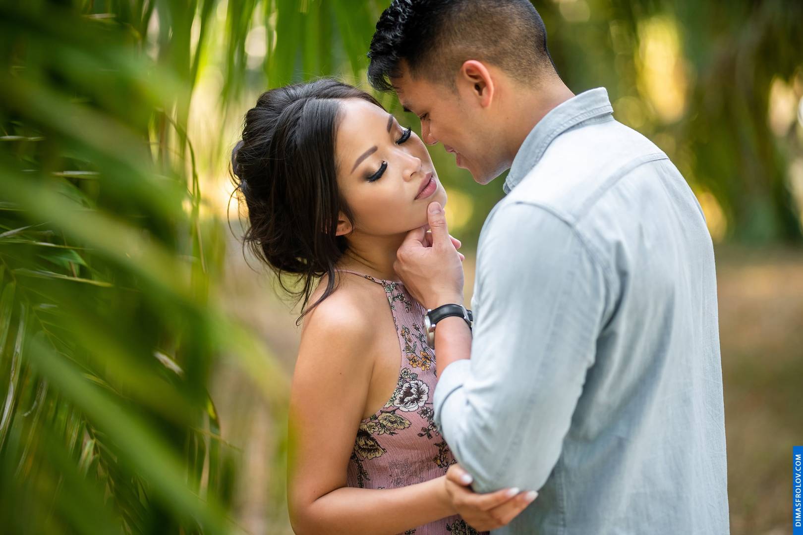 Romantic couple photo surrounded by lush greenery and soft light