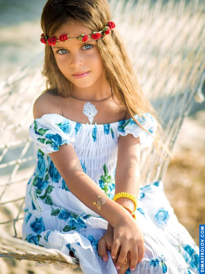 Styled kids portrait — girl in floral dress and flower crown in hammock